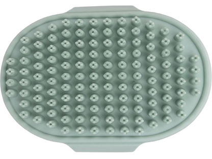 Green silicone scrubber with raised surface on a white background